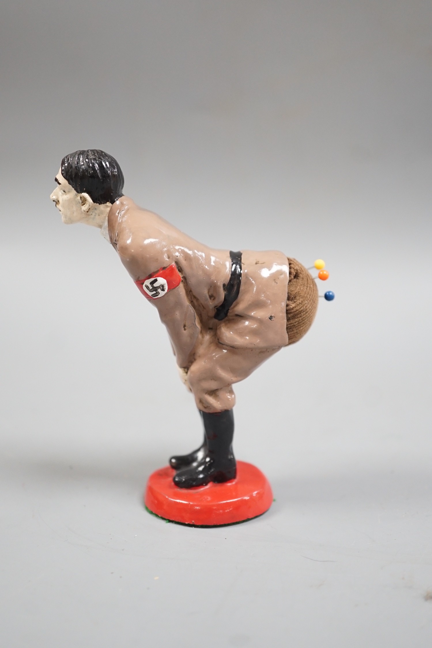 A painted metal ‘Adolf Hitler’ pin-cushion, 12cm